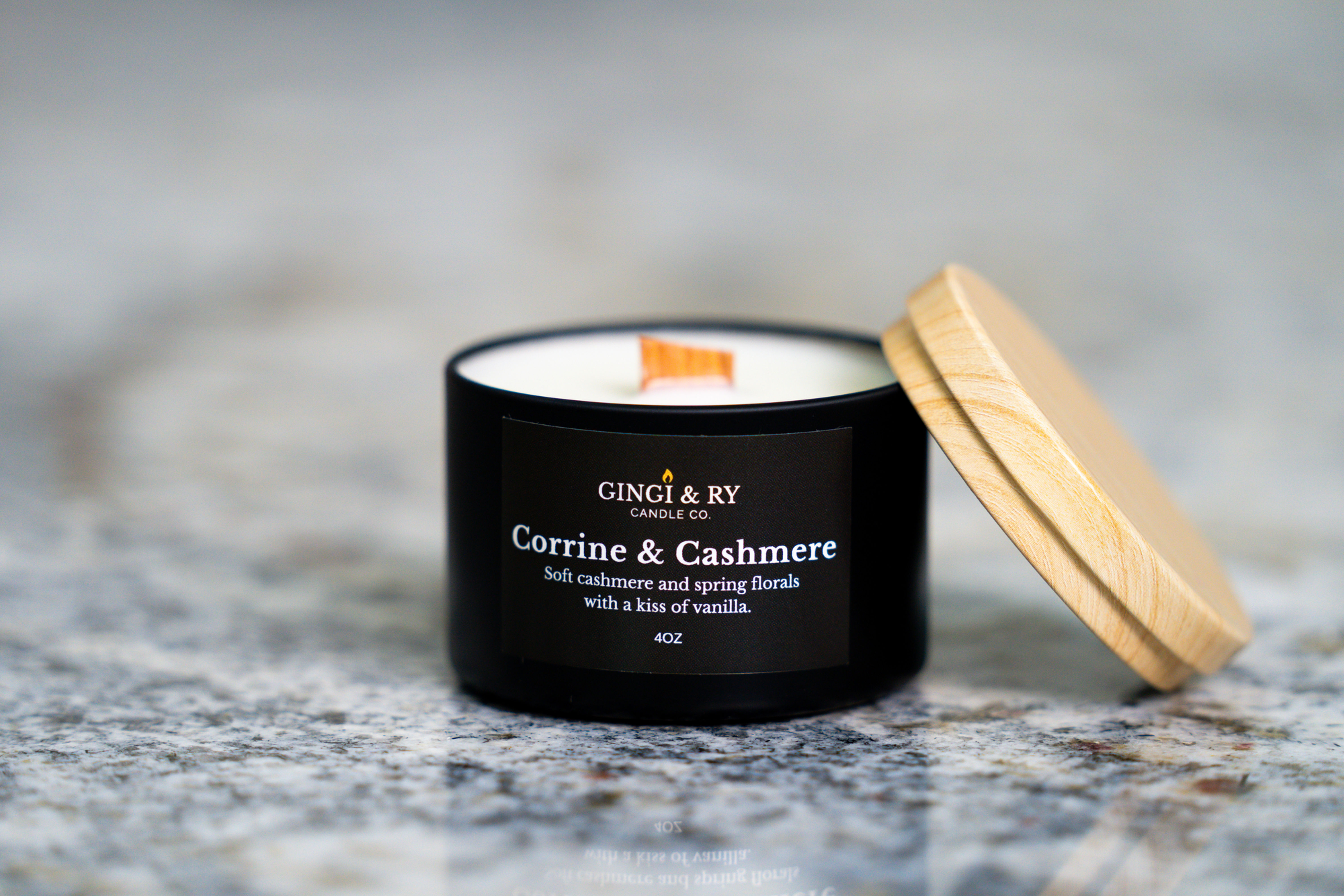 : Detail shot of the Corinne & Cashmere 4oz candle inspired by a heart preciouse like a flower on a marble countertop