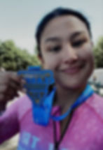 Smiling client holding an award medal