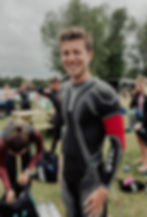 Smiling client in wetsuit after a race