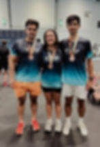 Three athletes smiling with medals