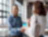 Hispanic man shaking hands with client in office