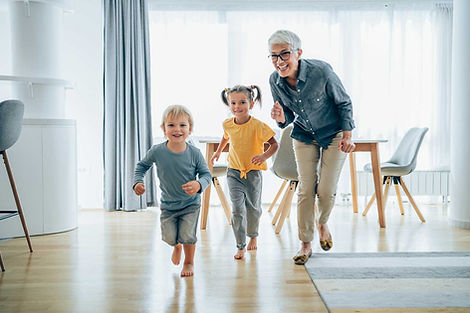 Grandmother chasing young grandchildren