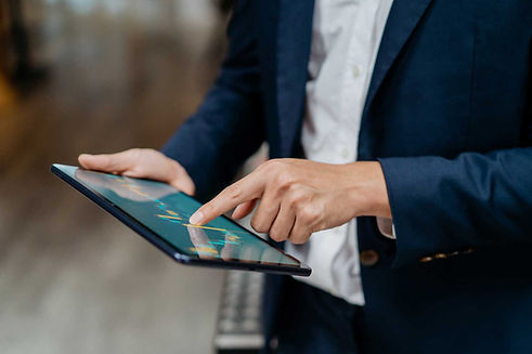 Business man looking at financial data on tablet
