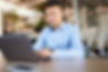 Car salesman at dealership working on computer