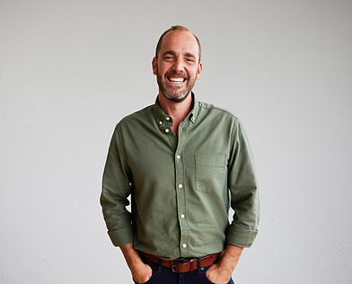Smiling professional bearded man in green shirt