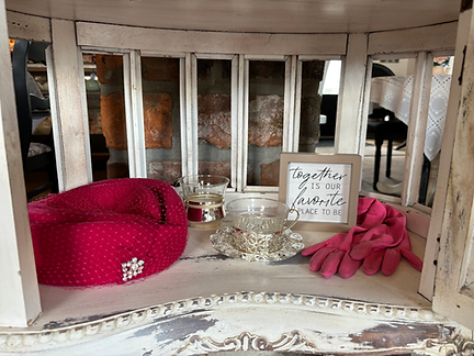 Pink hat and gloves with teacups and picture saying "Together is my favorite place to be" on an antique shelf