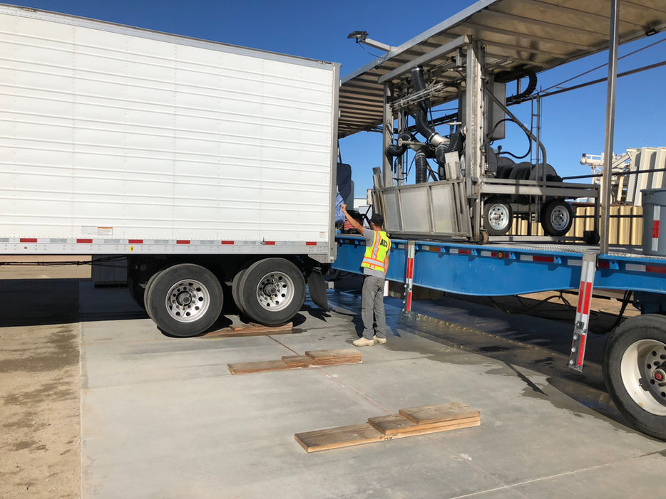 Truck backing up directed by employee