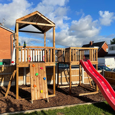 Twin towers climbing frame play tower in Euxton Chorley. With slide, climbing wall, ladder, rope ladder, rope bridge, roof