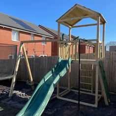 Climbing frame with two swings, slide, climbing wall, ladder
