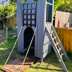 Bespoke castle themed climbing frame in Chorley. Featuring rope ladder, climbing wall, portcullis, drawbridge. Painted Silver Copse