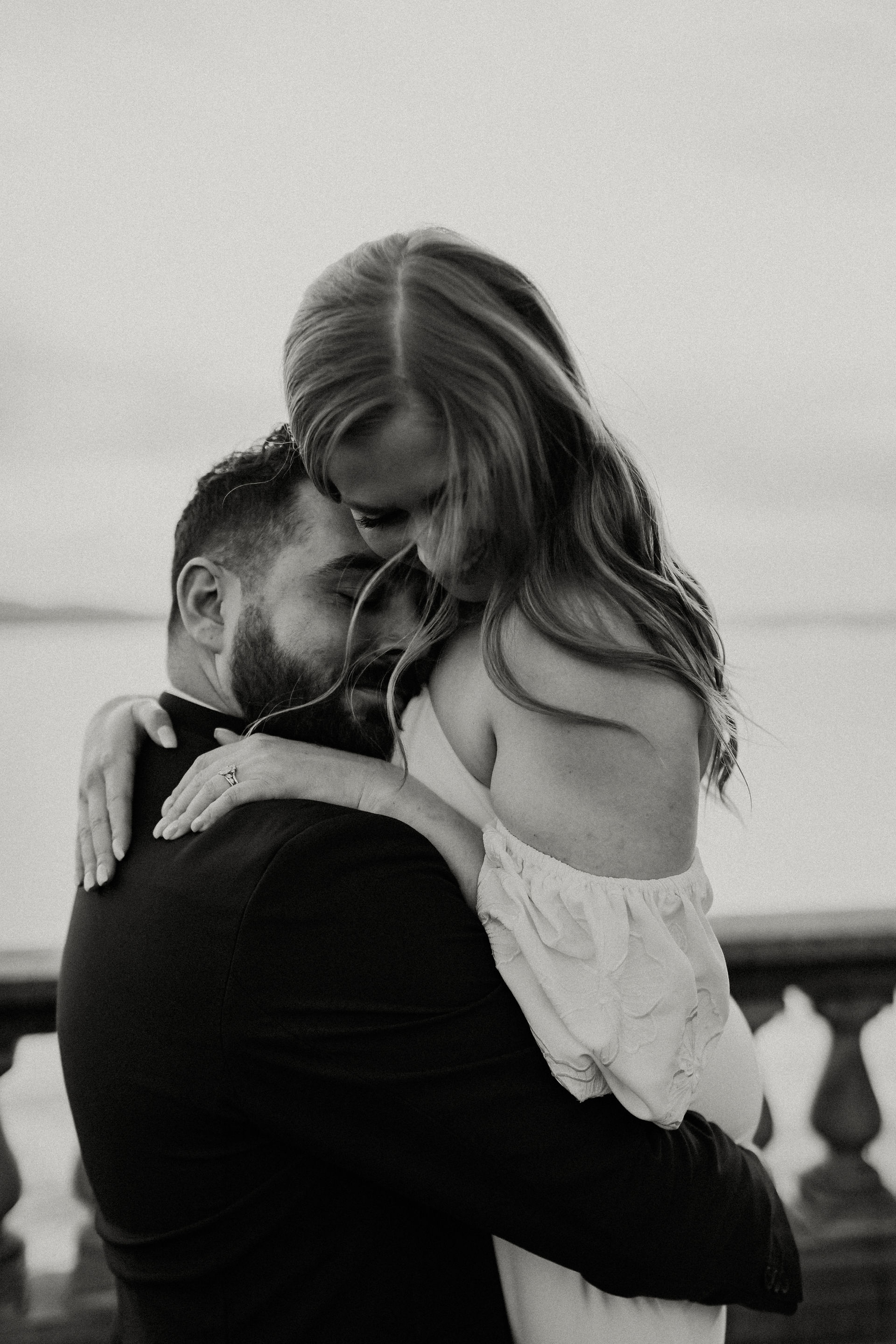 groom lifts bride, faces close together