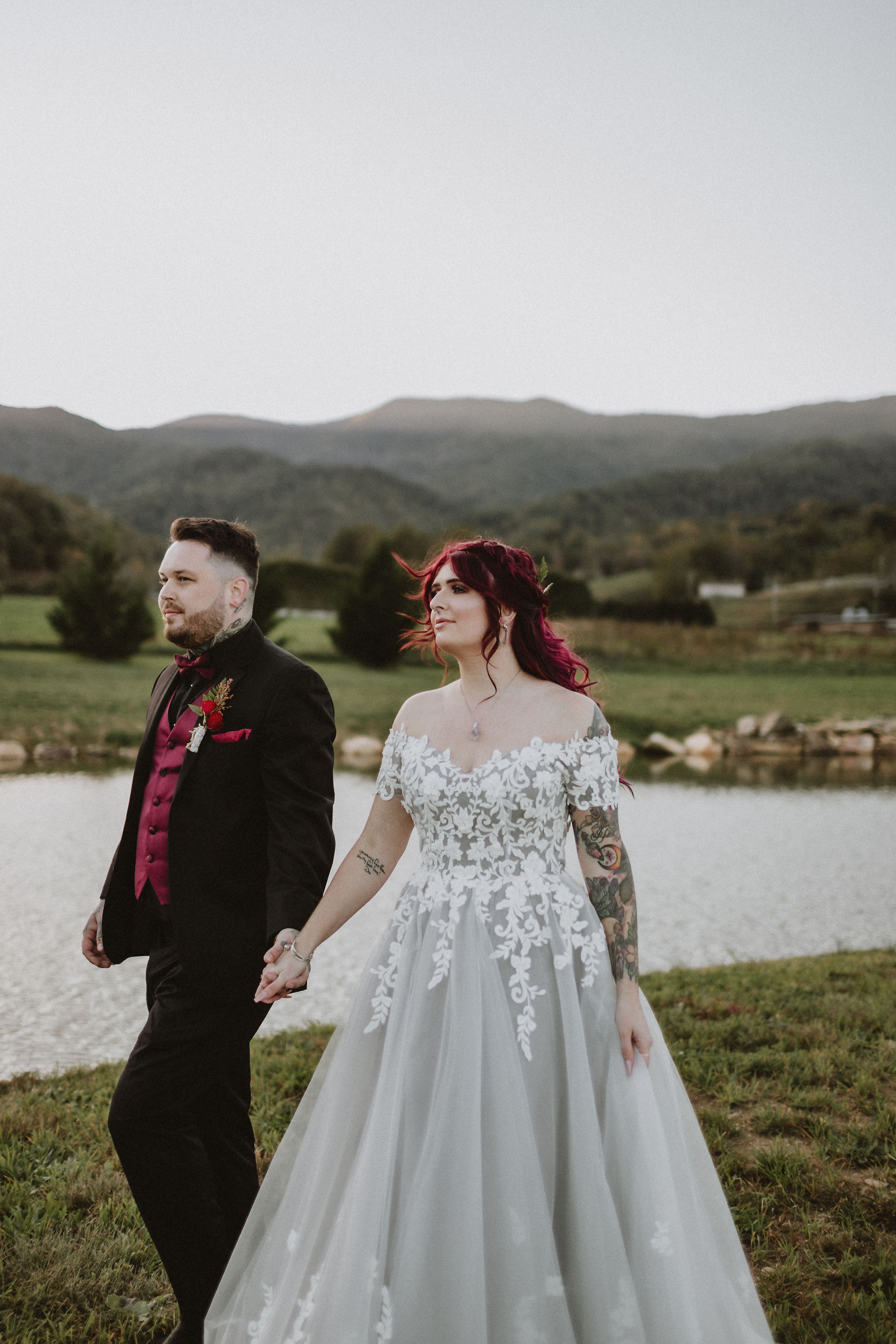 bride and groom walking holding hands looking off into distance