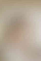 Bridesmaids helping bride in her dress.