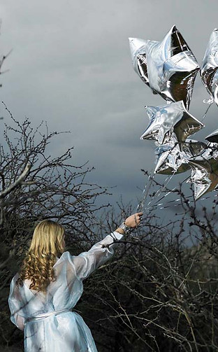 Woman with Silver Star Balloons