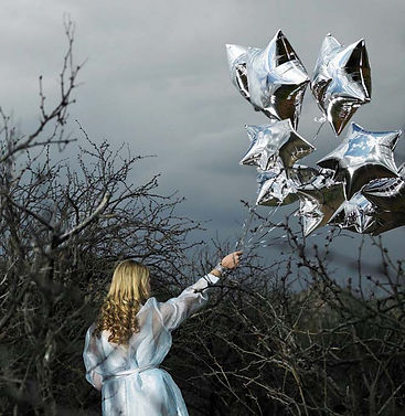 Woman with Silver Star Balloons