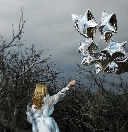 Woman with Silver Star Balloons