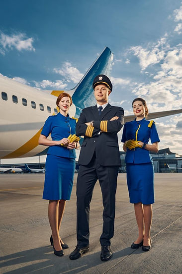 male-pilot-and-air-hostesses-posing-for-the-camera-outdoors-682x1024.jpg