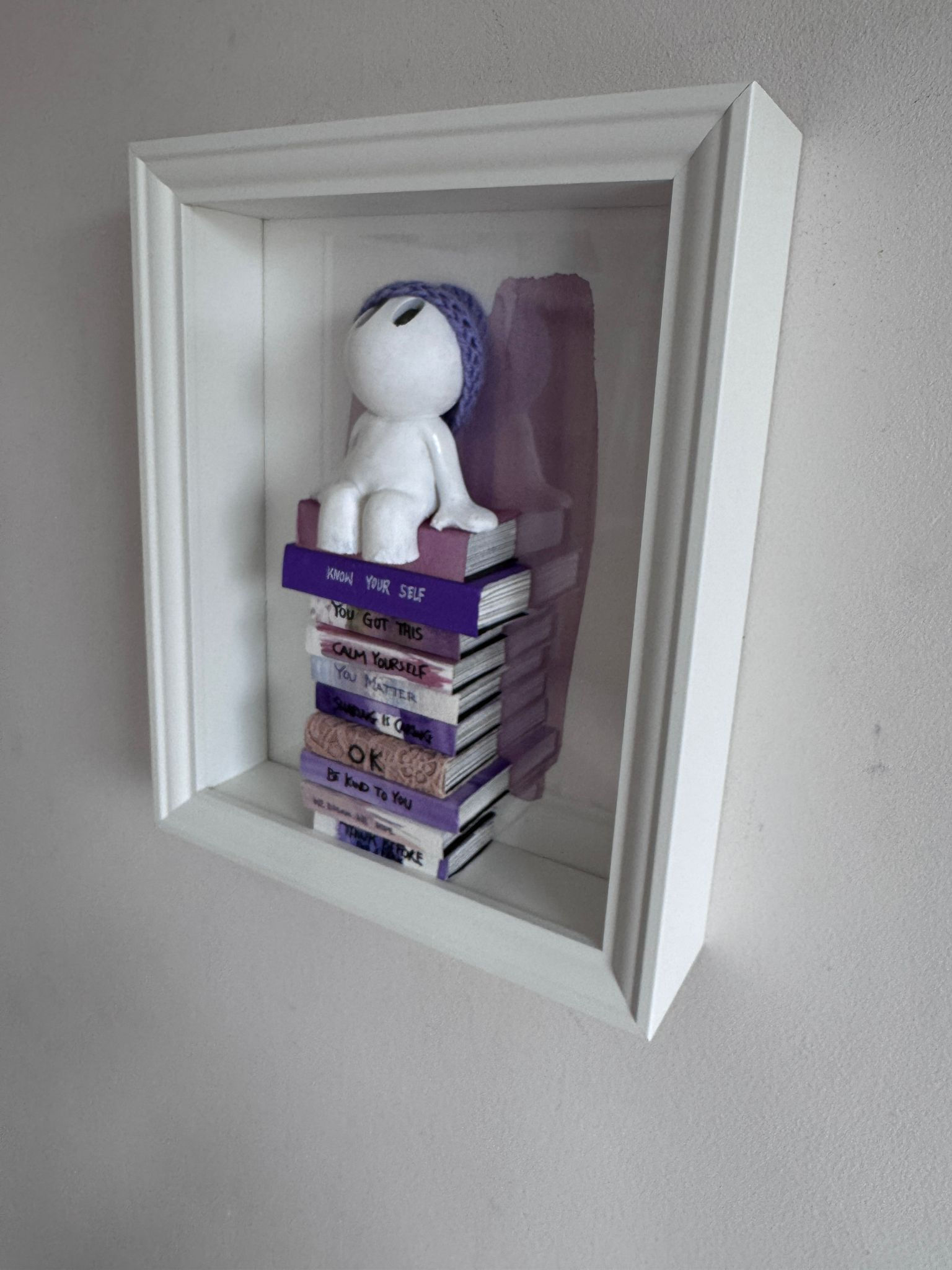 Purple Hat Mini books sit
