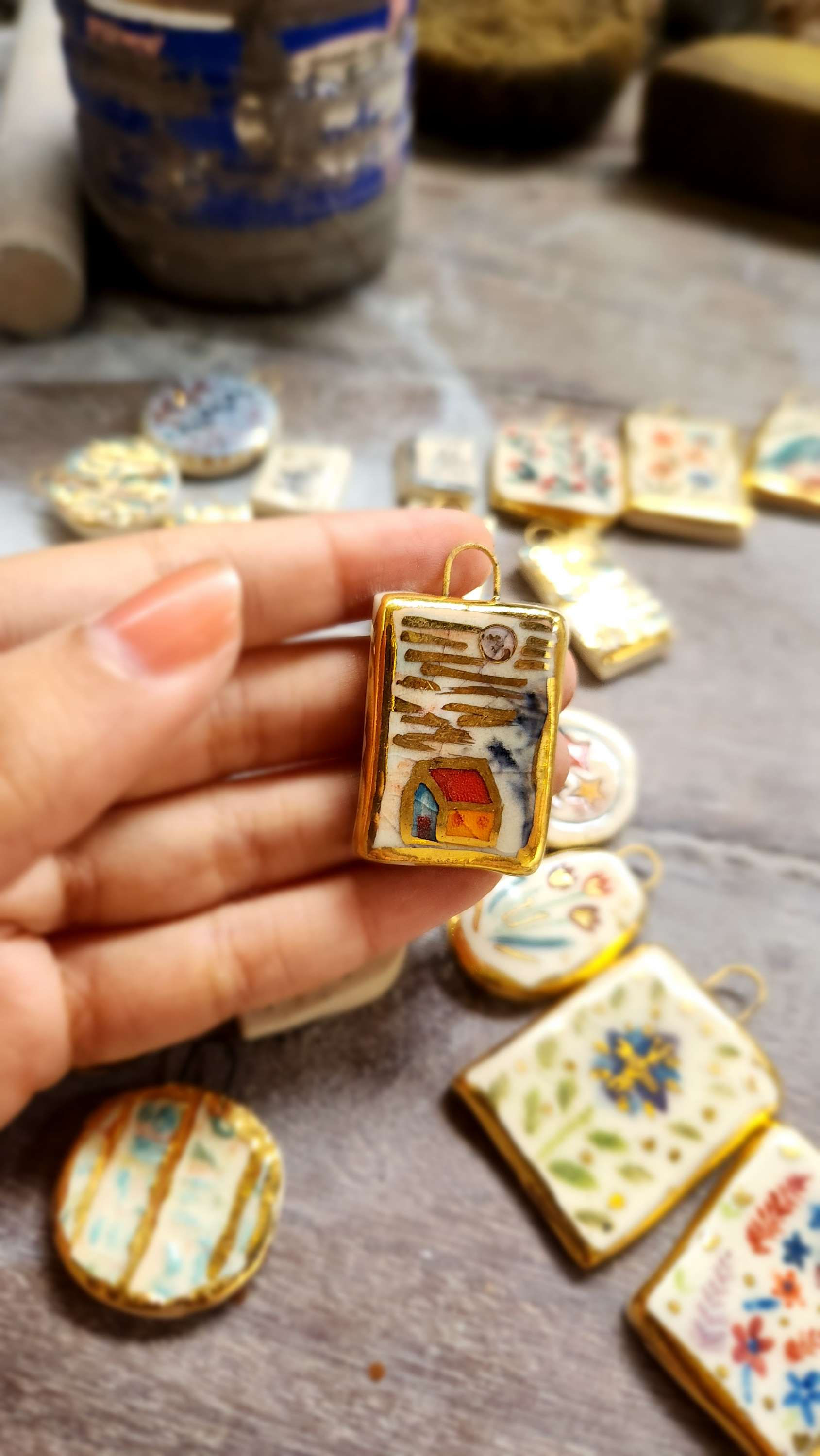 Ceramic pendant with house on it
