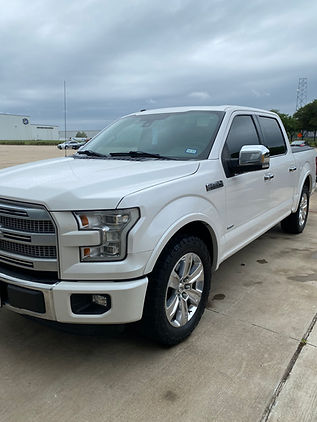 Auto detailing expert hand-washing a sports car for a flawless exterior finish.