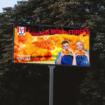 Print advertisement showing a man and woman eating KFC’s spiciest burger.