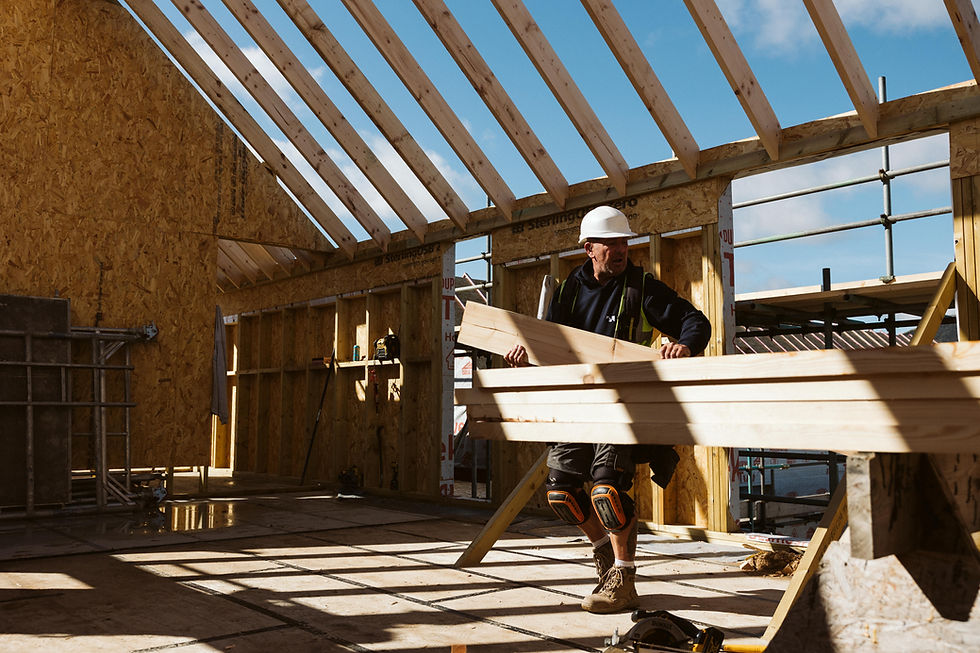 Worker building a sustainable timber frame house