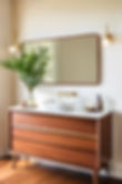 A mid-century modern design house, walnut vanity in a bright room..jpg