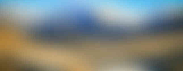 TranzAlpine scenic train with lake and snow capped mountains