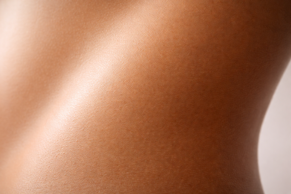 Close-up of smooth skin with a seamless gradient of natural tan, soft directional light revealing even tone transitions with no harsh lines or patchiness.