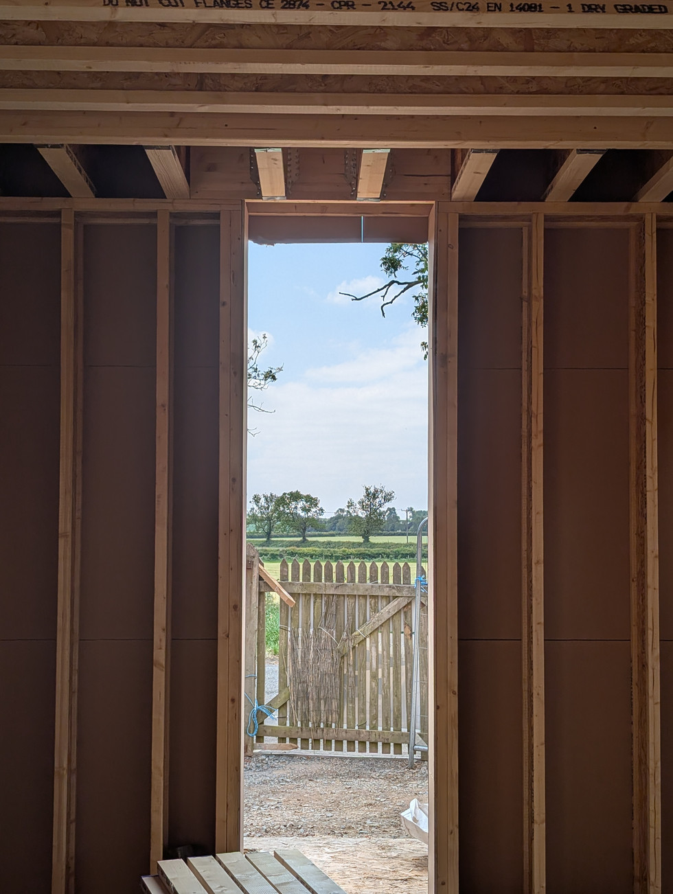 View of narrow vertical window inside in-construction timber house