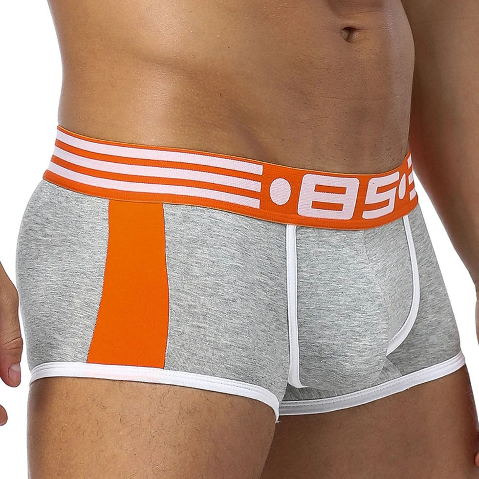 A man wearing gray boxers seen from the front