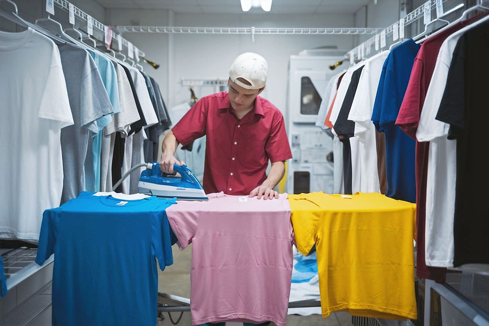 Portrait of a man caring for t-shirts, front view.