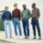 Portrait of four men (black and white) wearing H-shaped denims, different styles and colors, front view. 2