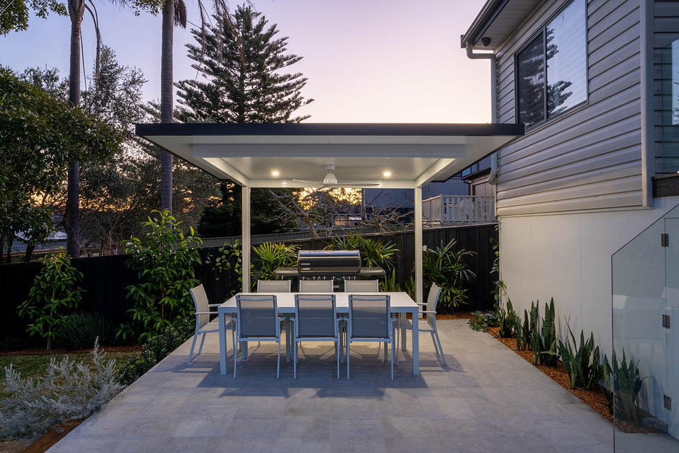 White Luxe Cantilever at dusk with dining table and chairs.
