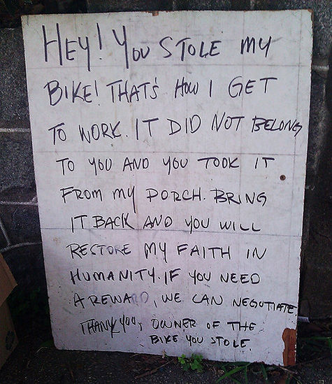 Handwritten sign: 'You stole my bike! Bring it back'