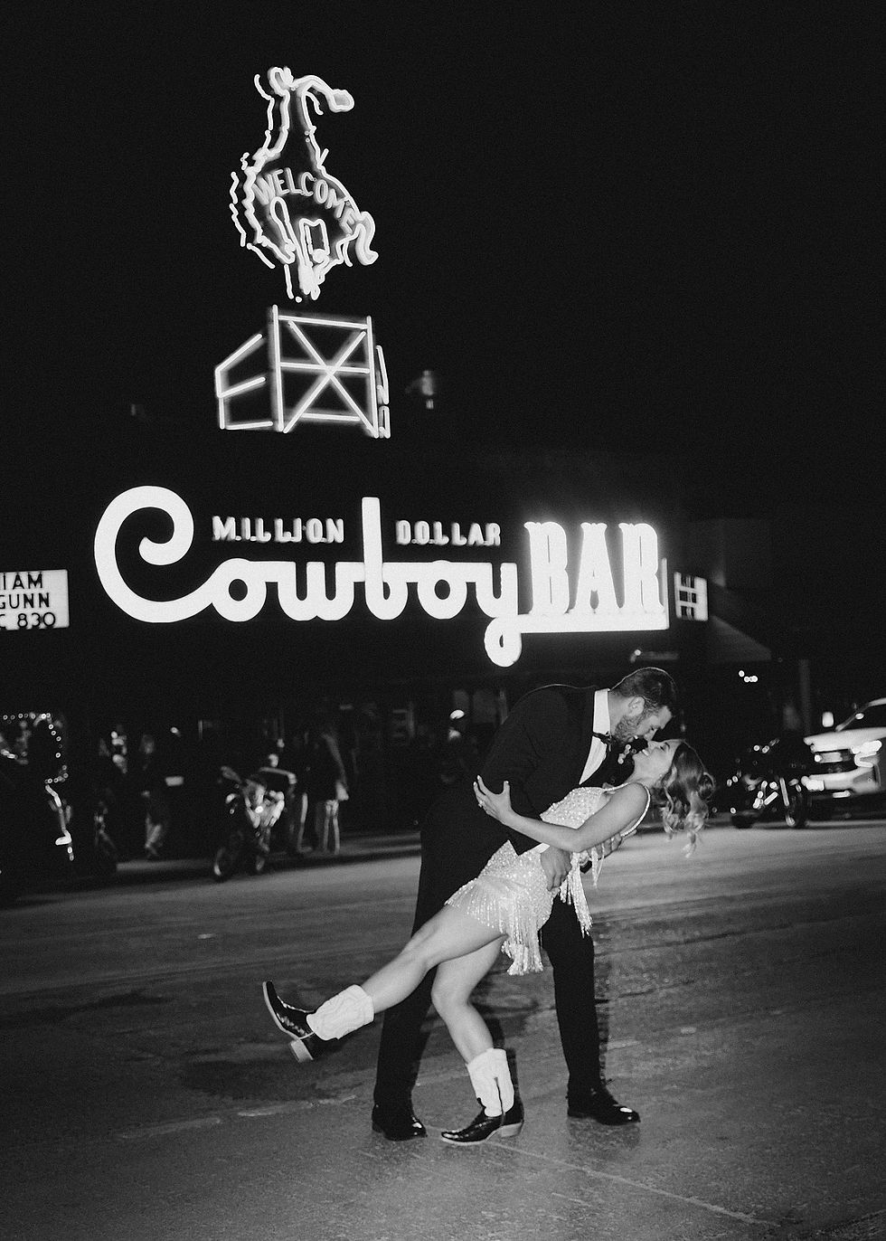 Bride and Groom kissing in front of the Million Dollar Cowboy Bar in Jackson Hole, WY