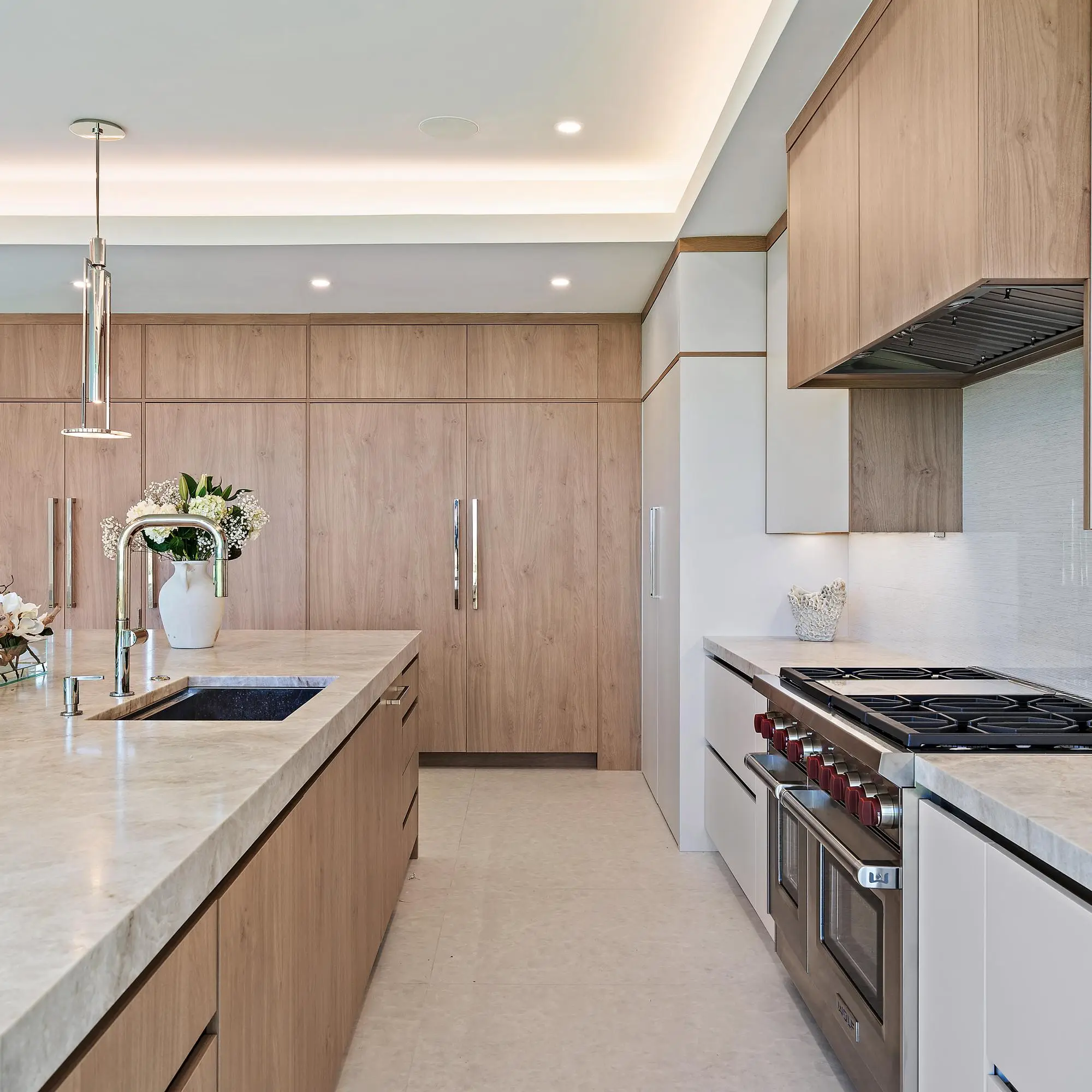 Contemporary kitchen with warm wood cabinetry and custom design elements