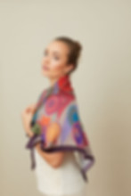 Model wearing a colourful scarf wrapped around the shoulders