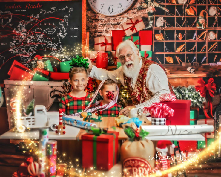 A magical and cozy photography studio set for a Santa Experience with evergreen trees and soft lights.