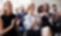 A class of happy professionals applauding