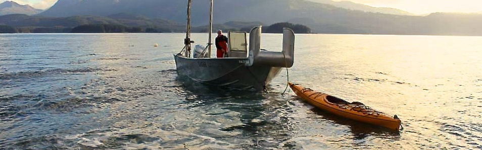 Eric Olsen in boat with kayak