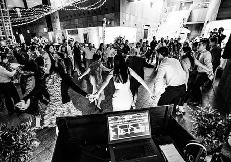 Black-and-white overhead of a crowded wedding dance floor at Christchurch Art Gallery.