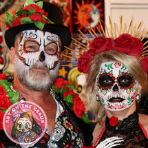 Couple body painted as sugar skulls for Halloween party in Bogalusa, LA.