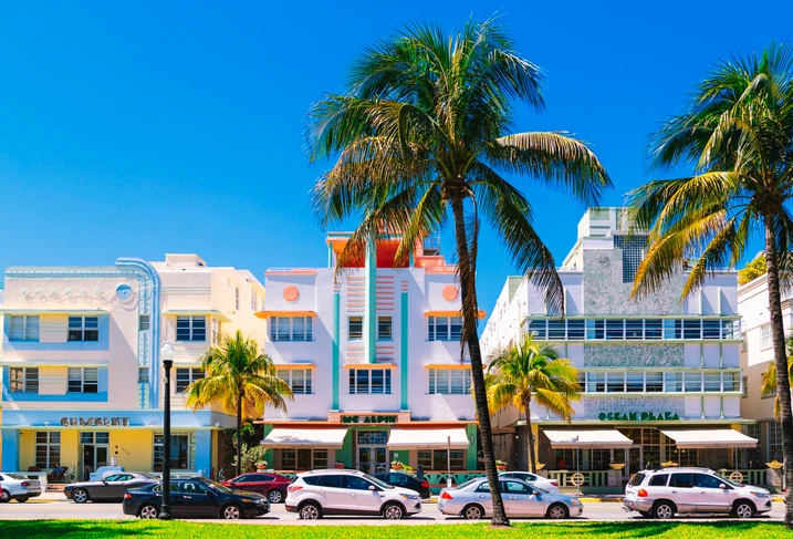 Ocean Drive at daytime, with lined up palm trees.