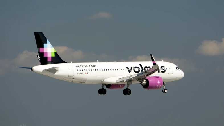 Volaris airbus flying across the sky.