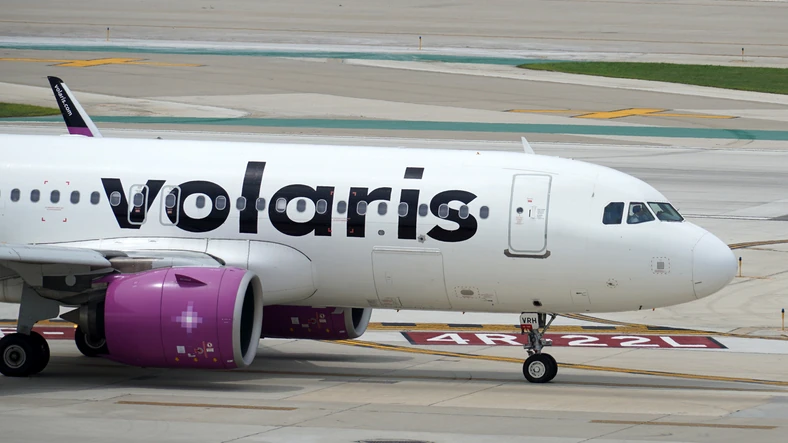 The front side of a Volaris airbus in the airport platform.