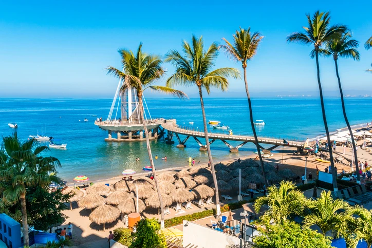 Panoramic view of Malecón boardwalk and palm trees in Puerto Vallarta on a sunny day.