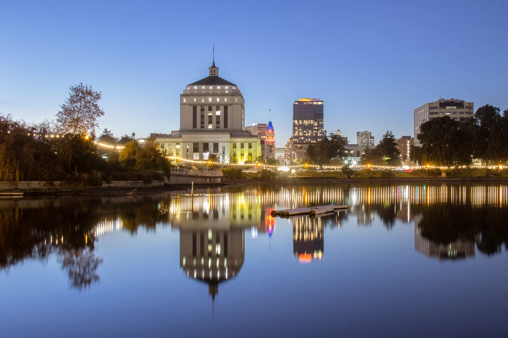 Oakland skyline on the other side of Lake Merrit at night.