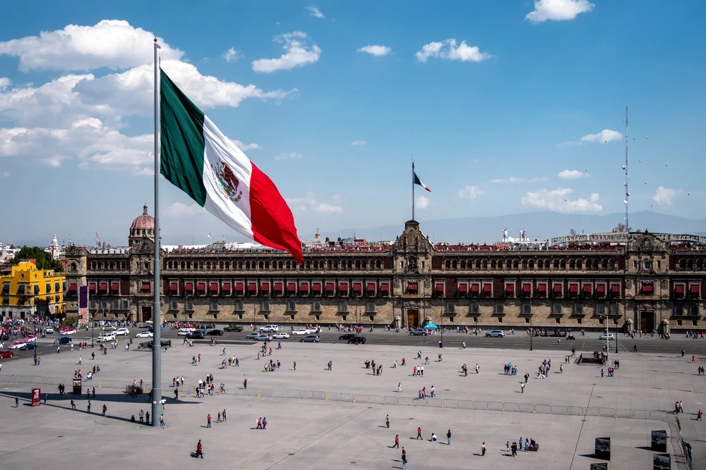 Mexican flag waving in National Palace at Plaza de la Constitución, Mexico City.