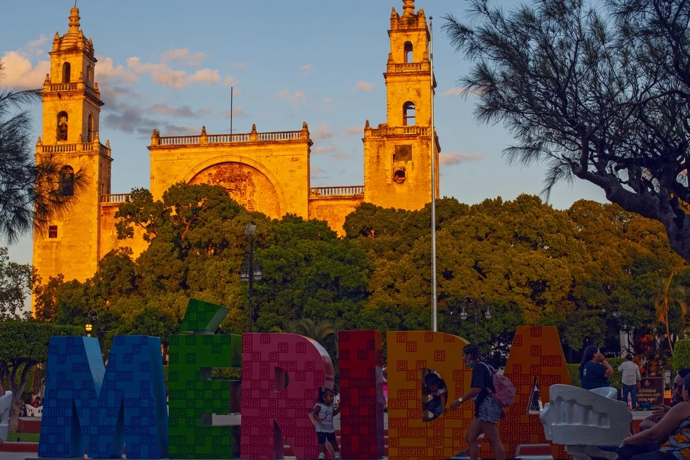 Colorful Merida sign and the Cathedral at Plaza Grande.